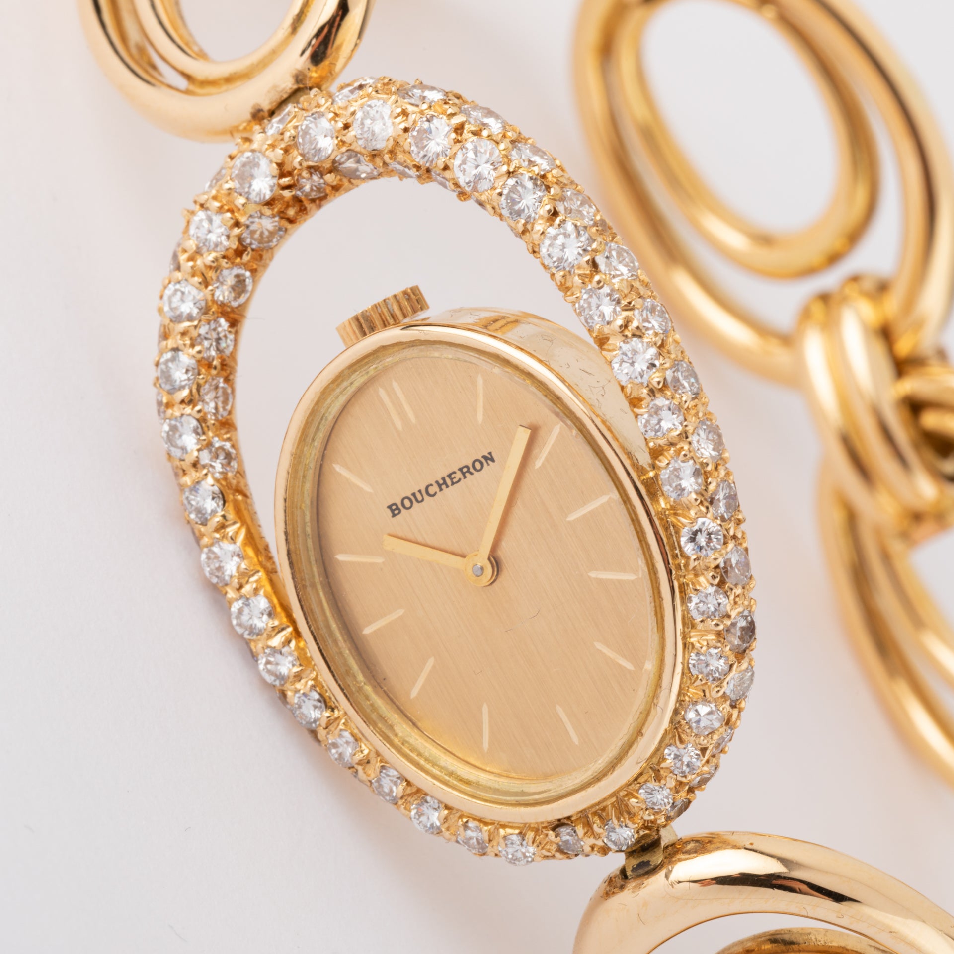 Boucheron, a gold and diamond watch on gold