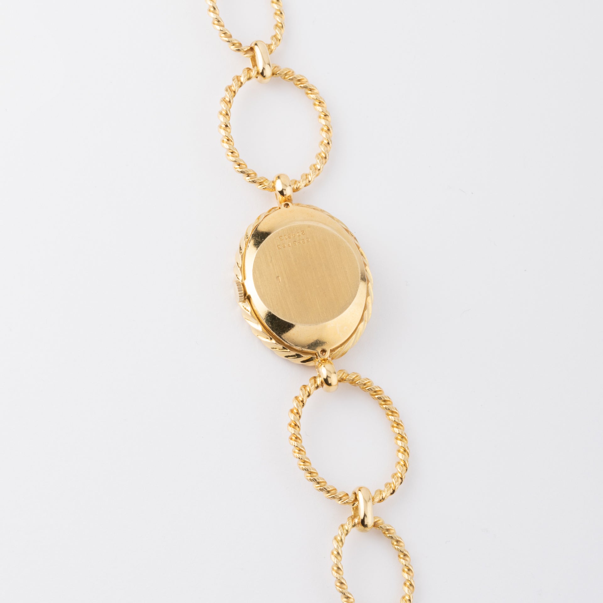Vintage Piaget, a gold and tiger's eye watch on gold.