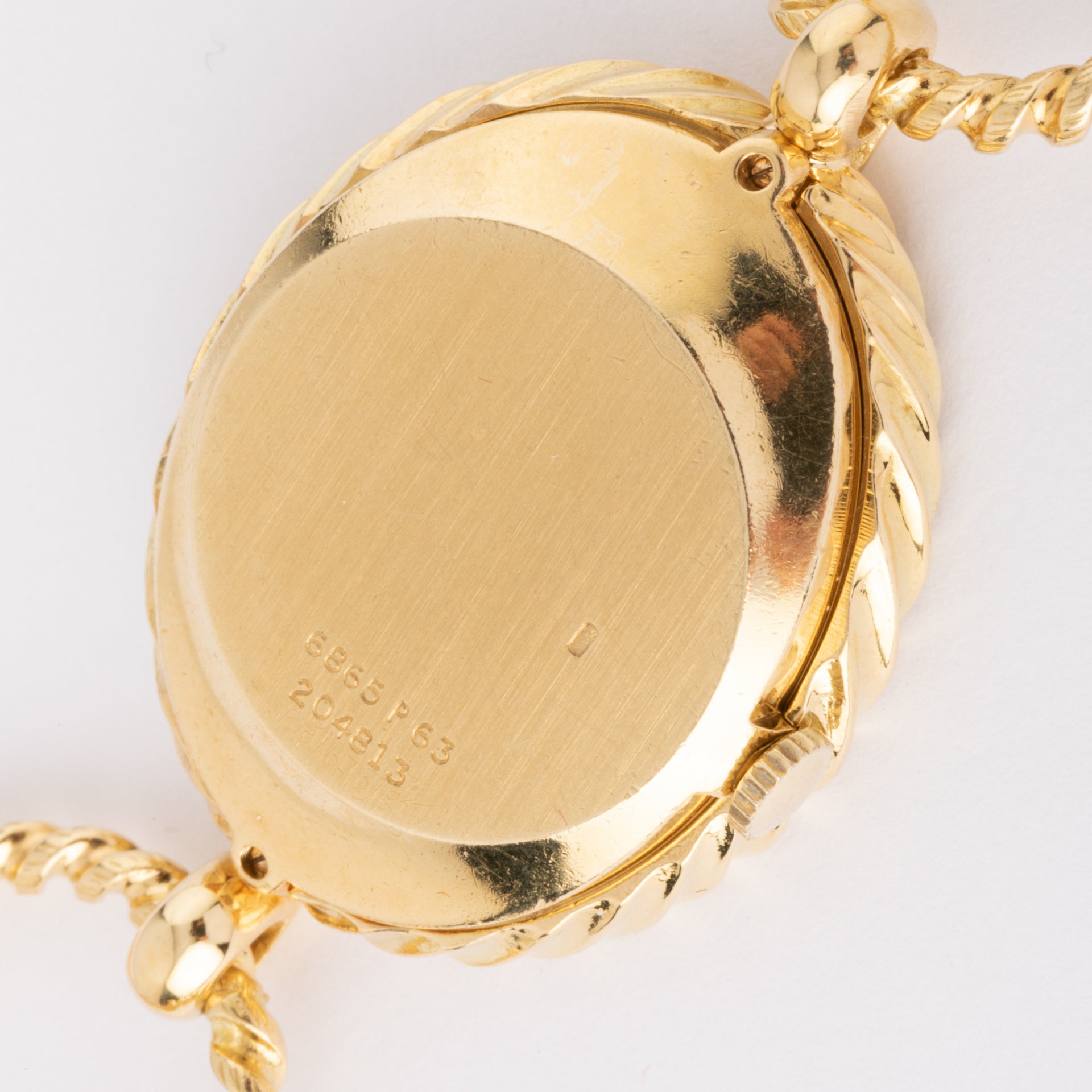 Vintage Piaget, a gold and tiger's eye watch on gold.