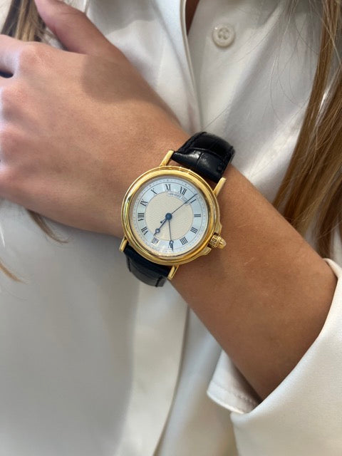A Breguet "Marine" watch in yellow gold.