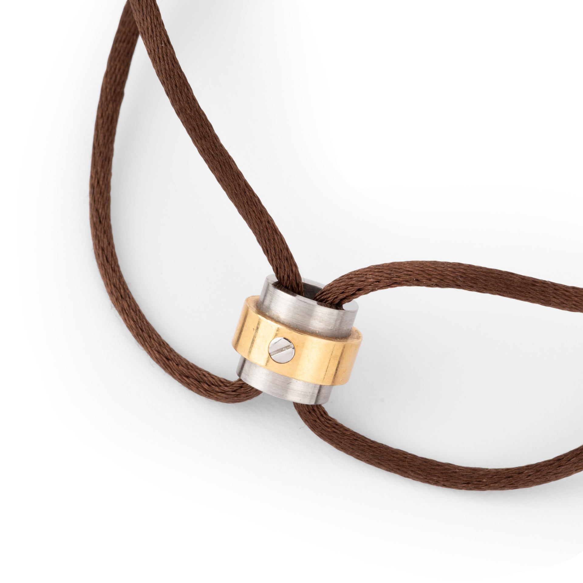 A Cartier gold and steel bracelet on a leather cord