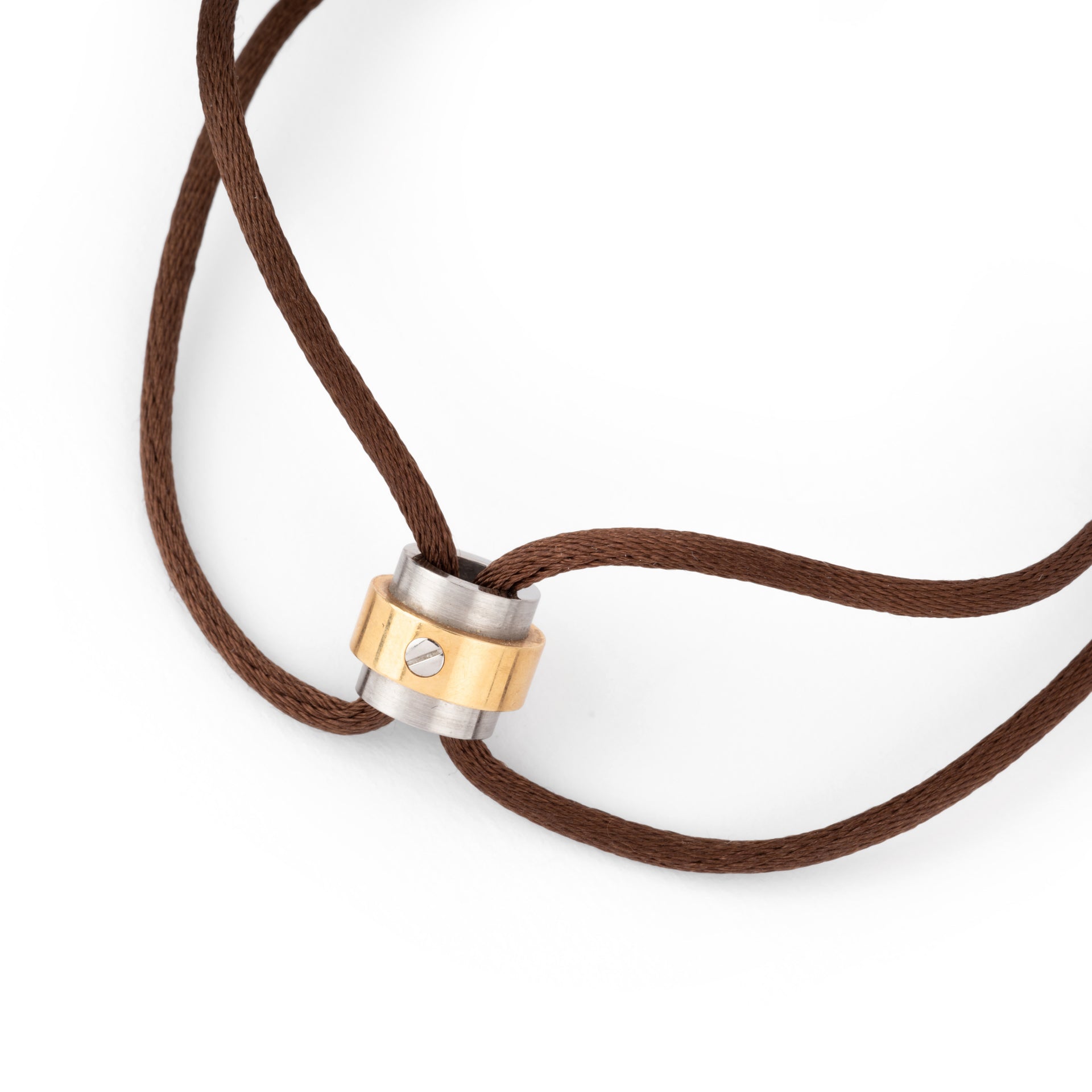 A Cartier gold and steel bracelet on a leather cord