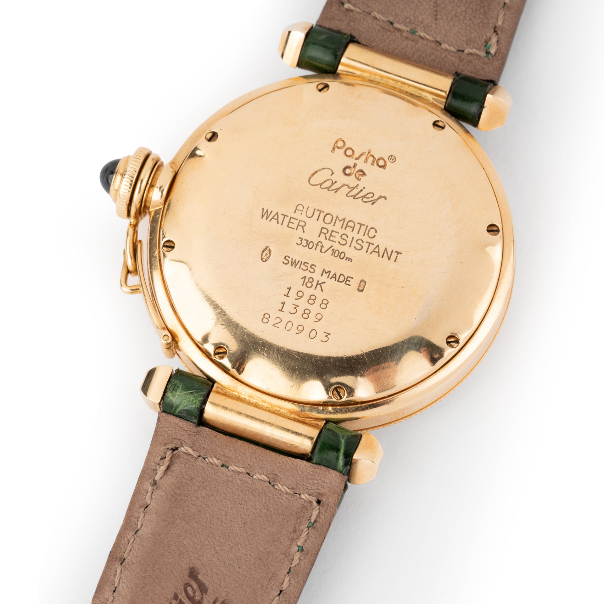 A Cartier "Pasha" watch in yellow gold on a leather strap