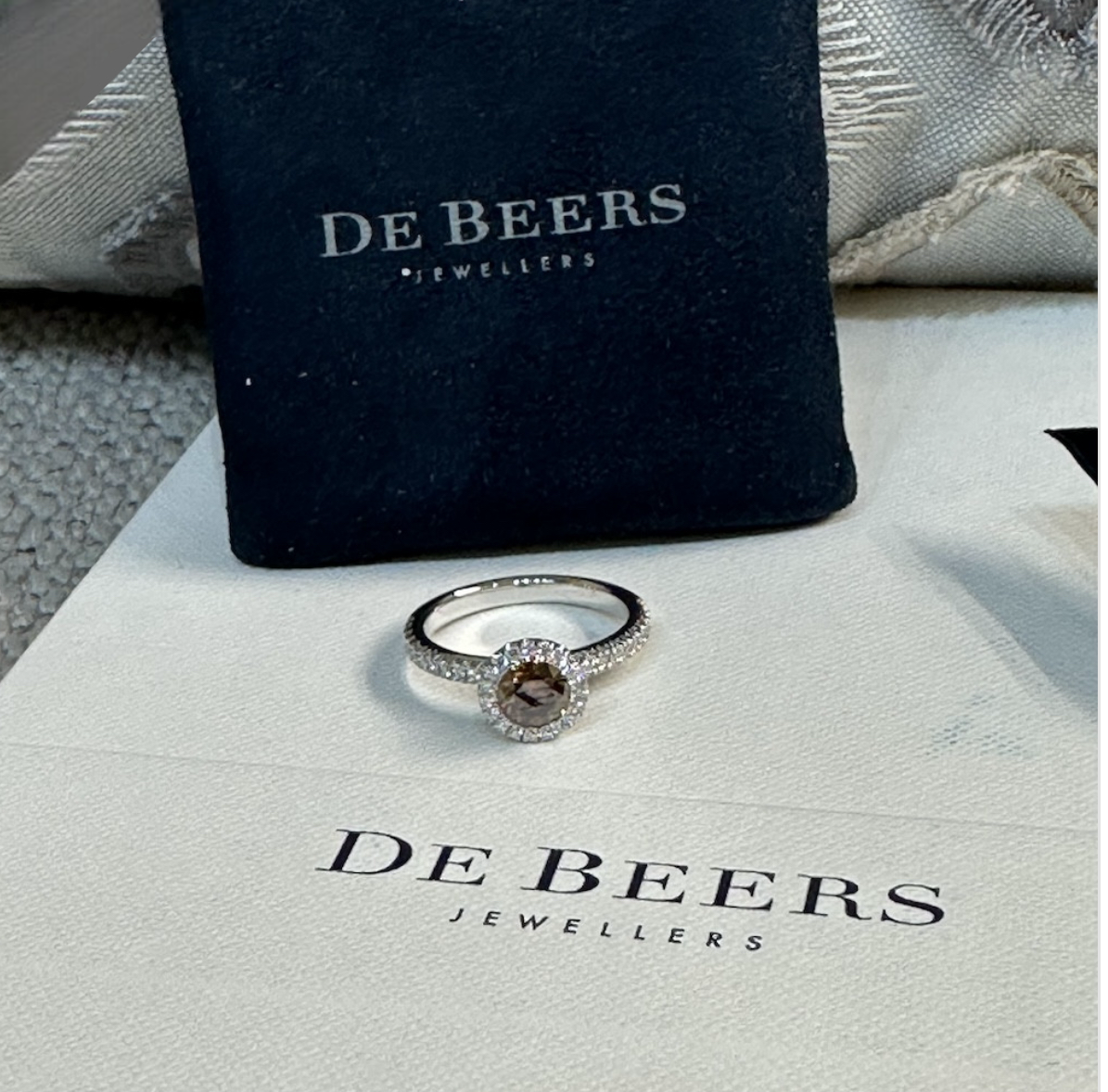 De Beers solitaire "Aura" in platinum, Fancy Dark Brown diamond, full set.
