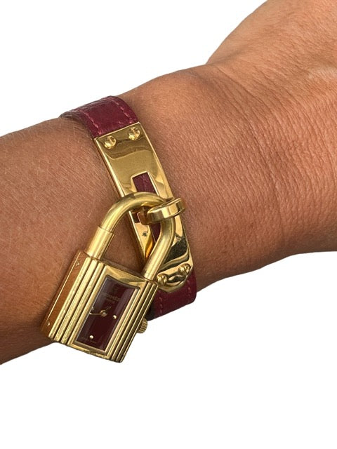 Hermès, Kelly gold-plated watch, burgundy dial