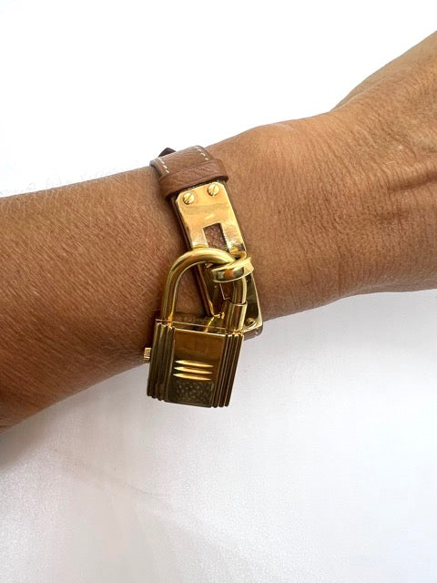 Hermès Kelly watch on gold leather strap