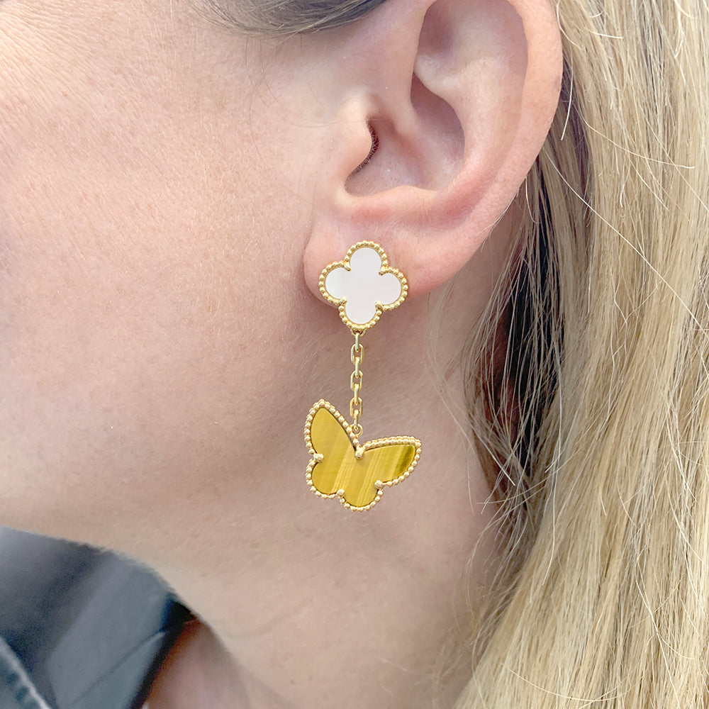 Van Cleef & Arpels "Lucky Alhambra" earrings in yellow gold, white mother-of-pearl, tiger's eye.