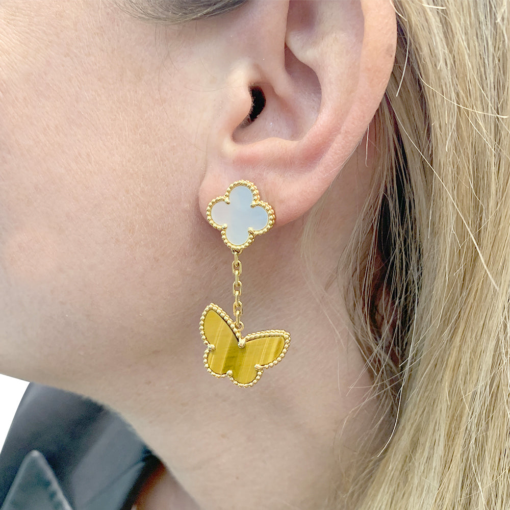 Van Cleef & Arpels "Lucky Alhambra" earrings in yellow gold, white mother-of-pearl, tiger's eye.