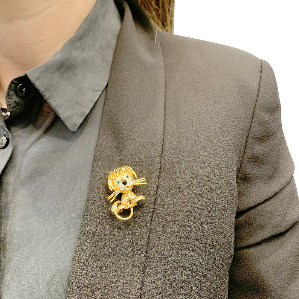 Van Cleef & Arpels brooch, "Ruffled Lion", in yellow gold, diamonds, emeralds and enamel.