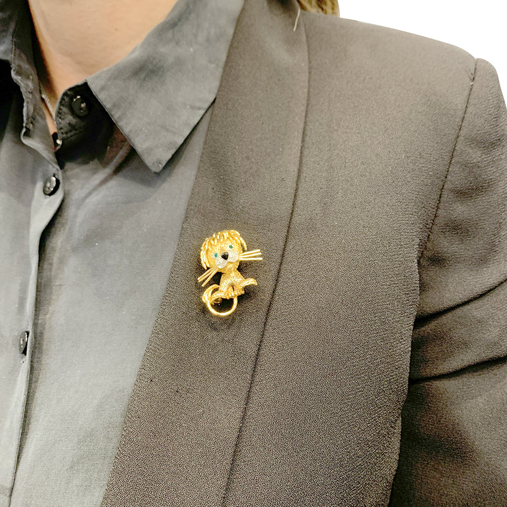 Van Cleef & Arpels brooch, "Ruffled Lion", in yellow gold, diamonds, emeralds and enamel.