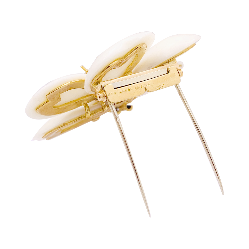 Van Cleef & Arpels "Christmas Rose" brooch in yellow gold, white coral, diamonds.