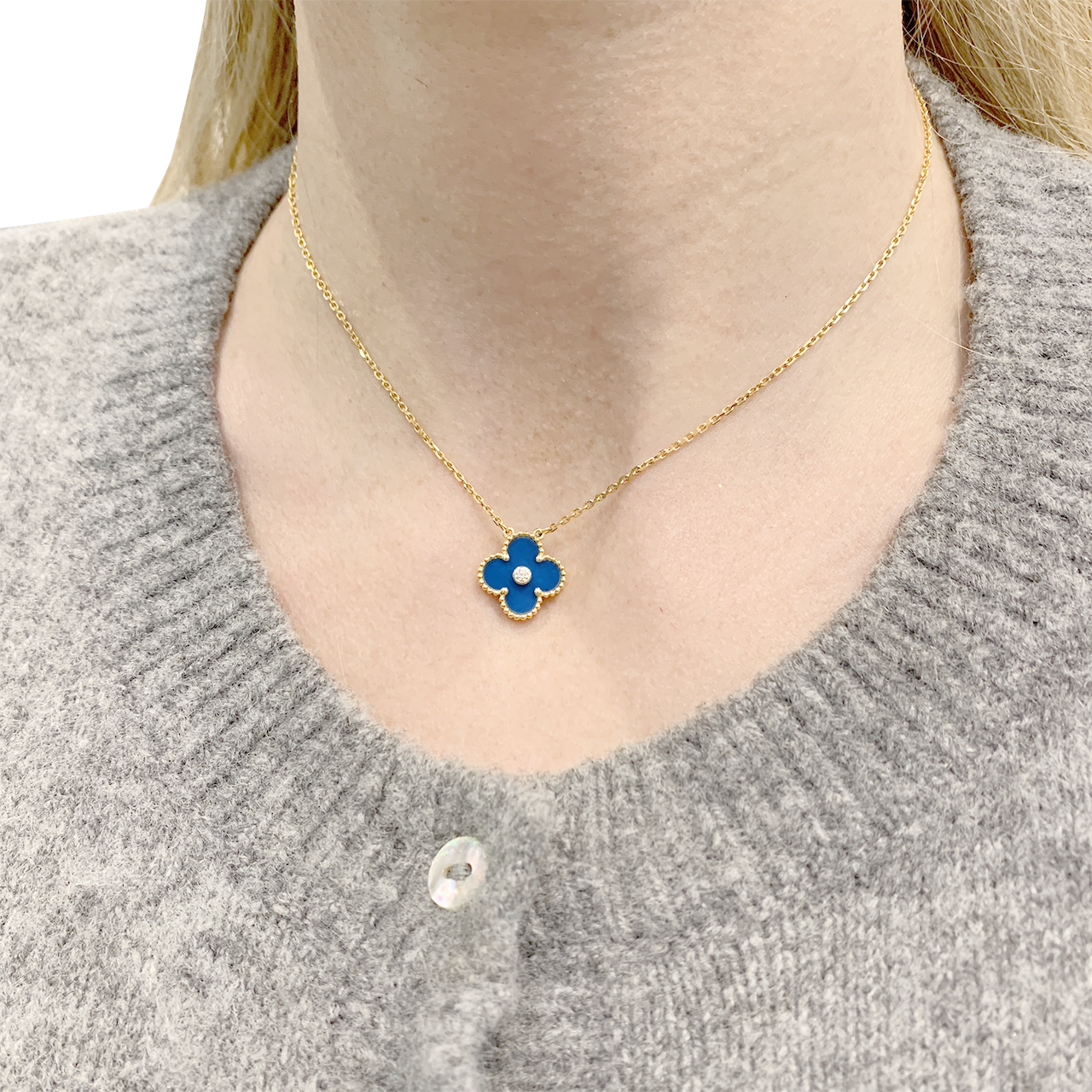 Van Cleef & Arpels "Alhambra" necklace in yellow gold, porcelain, and diamond.