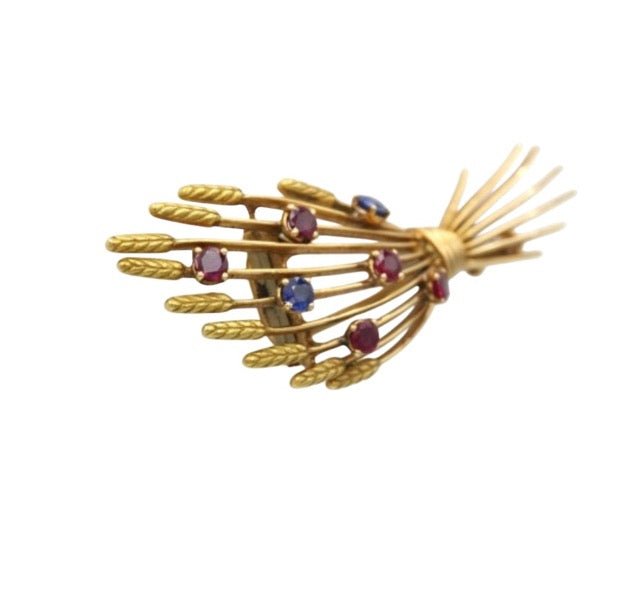 Mellerio, broche vintage en or jaune 18K rubis et saphirs - Maison Eloe
