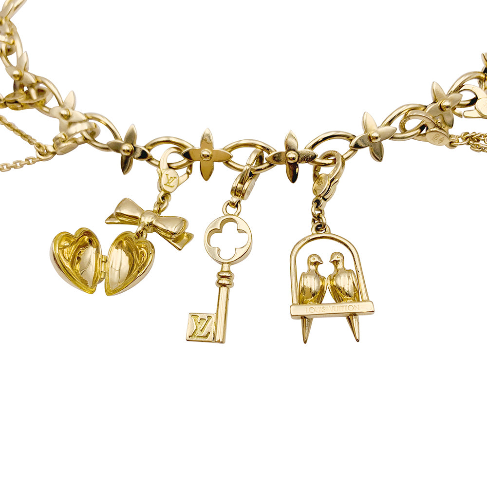 Bracelet Louis Vuitton, "Idylle",  breloques, or jaune, or blanc, perles.