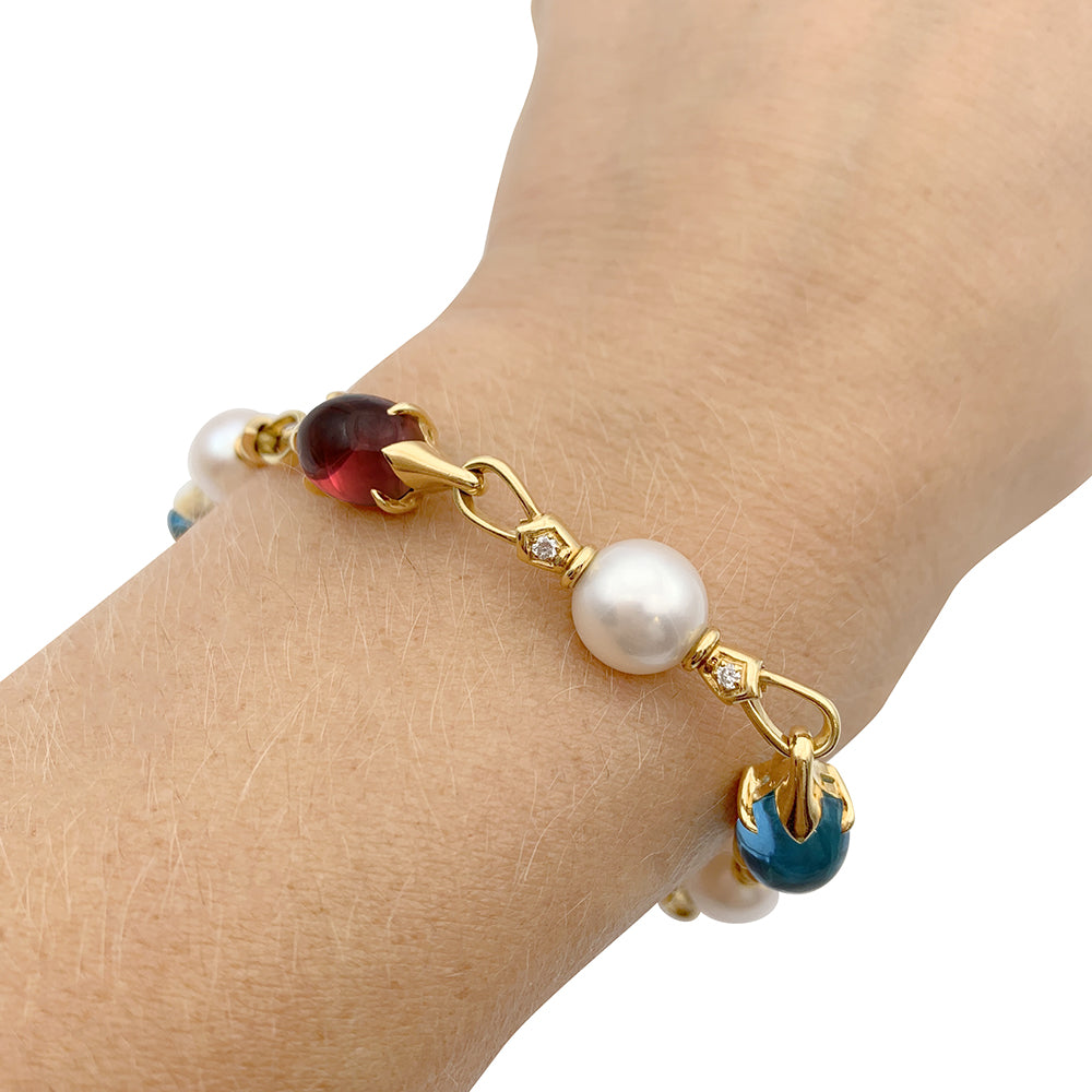 Bulgari bracelet in yellow gold, pearls, colored stones.