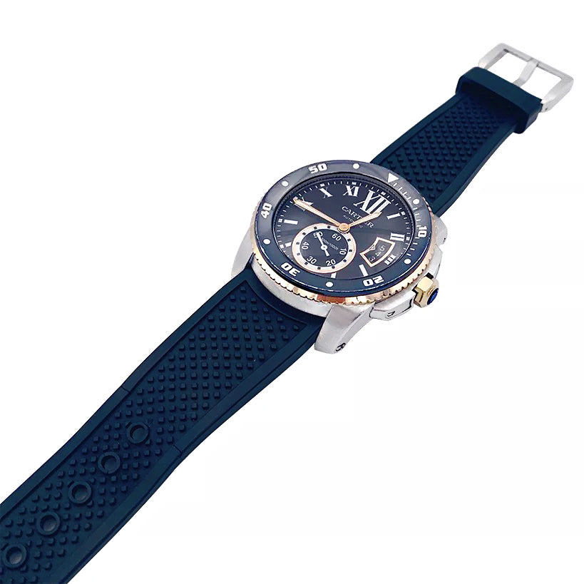 Cartier Calibre watch in gold and steel on a rubber strap.