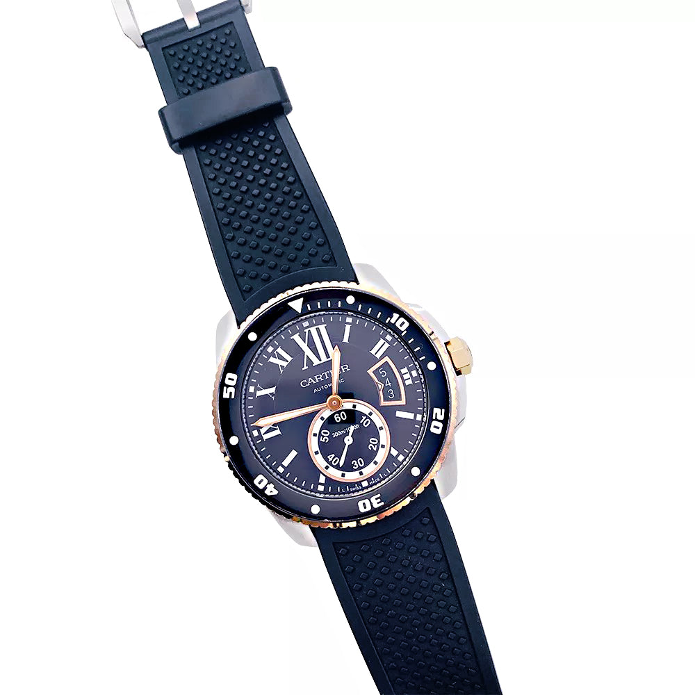 Cartier Calibre watch in gold and steel on a rubber strap.
