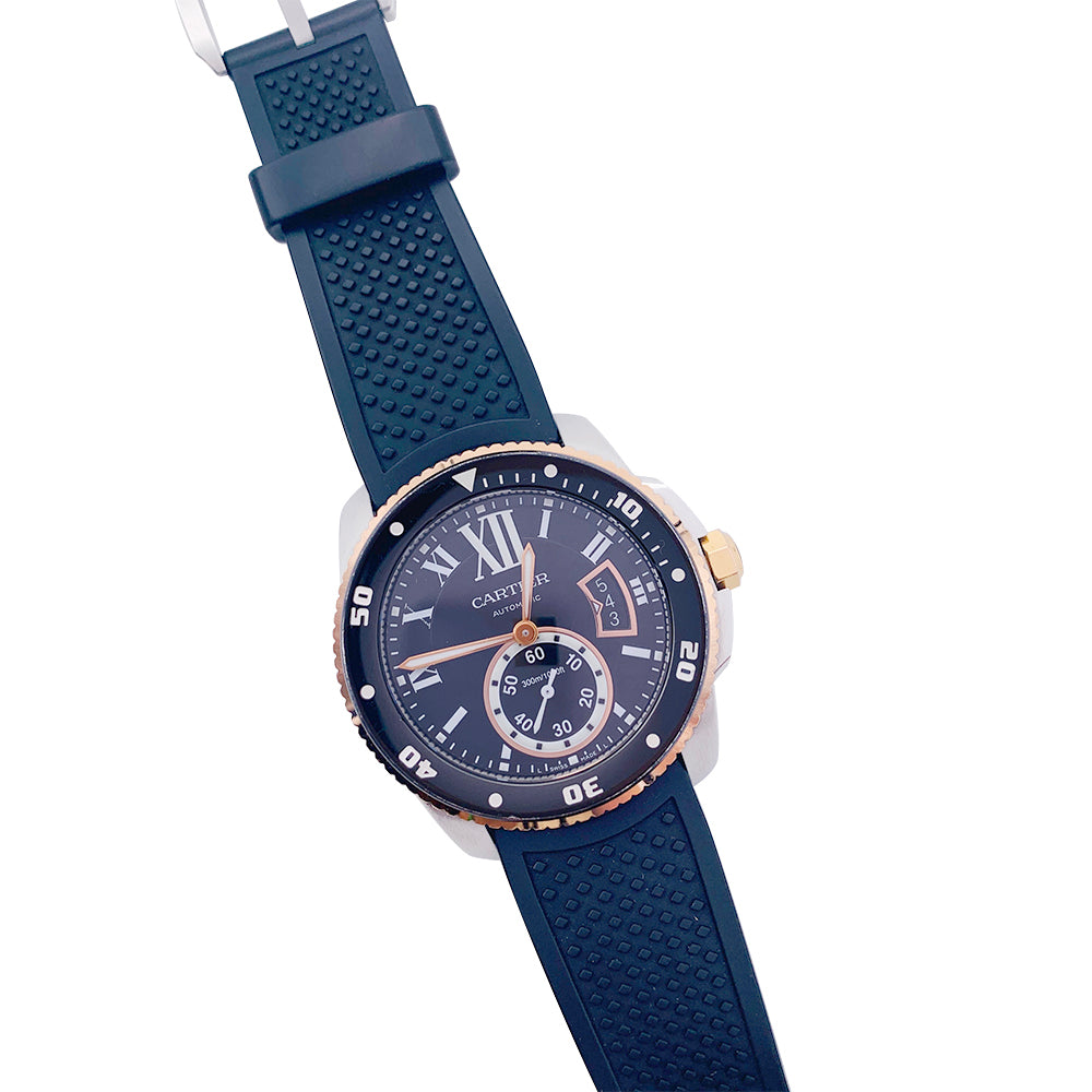 Cartier Calibre watch in gold and steel on a rubber strap.
