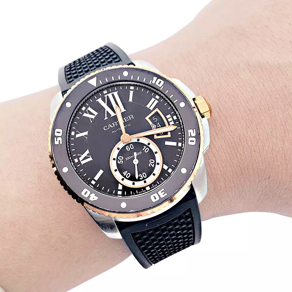 Cartier Calibre watch in gold and steel on a rubber strap.