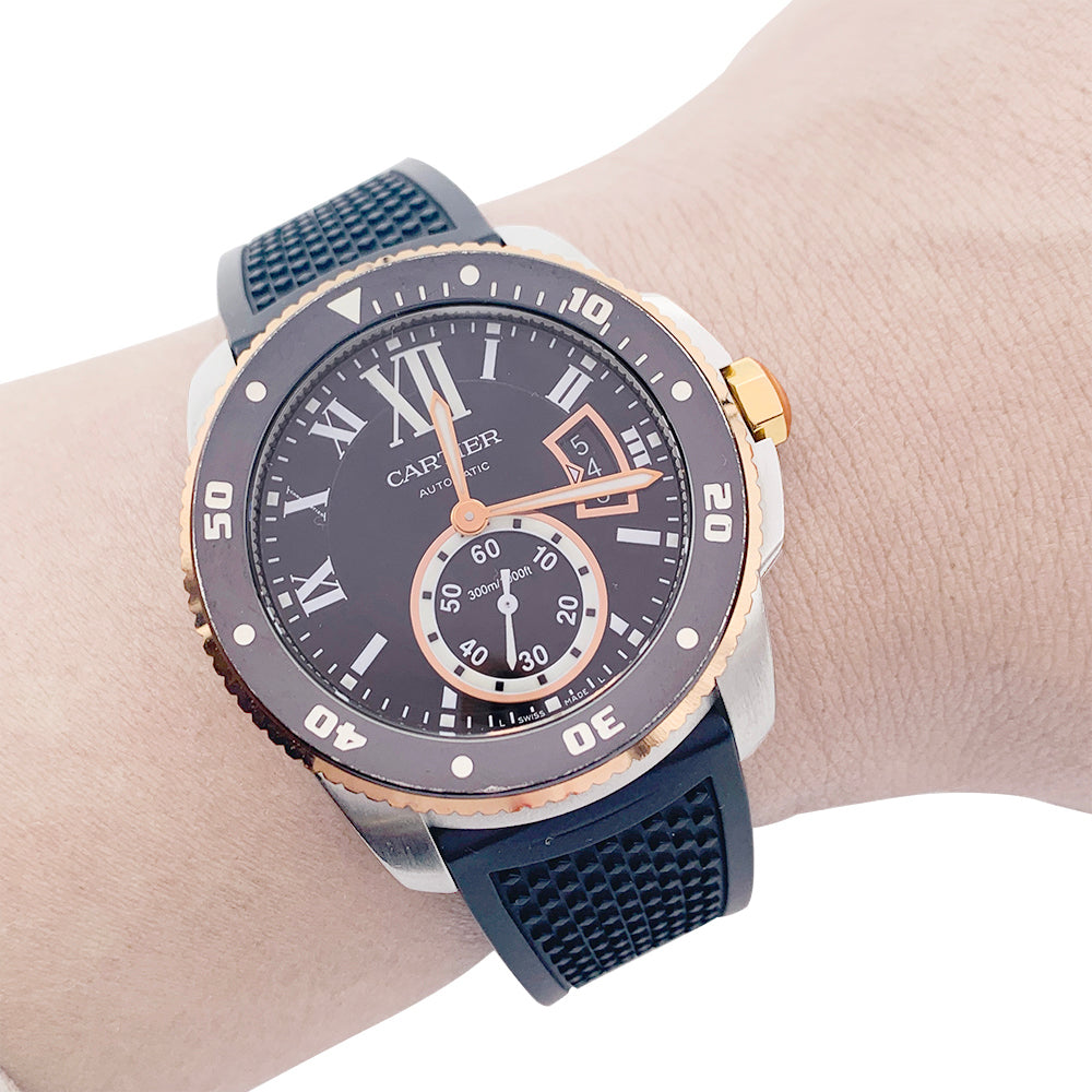 Cartier Calibre watch in gold and steel on a rubber strap.