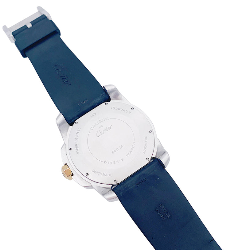 Cartier Calibre watch in gold and steel on a rubber strap.