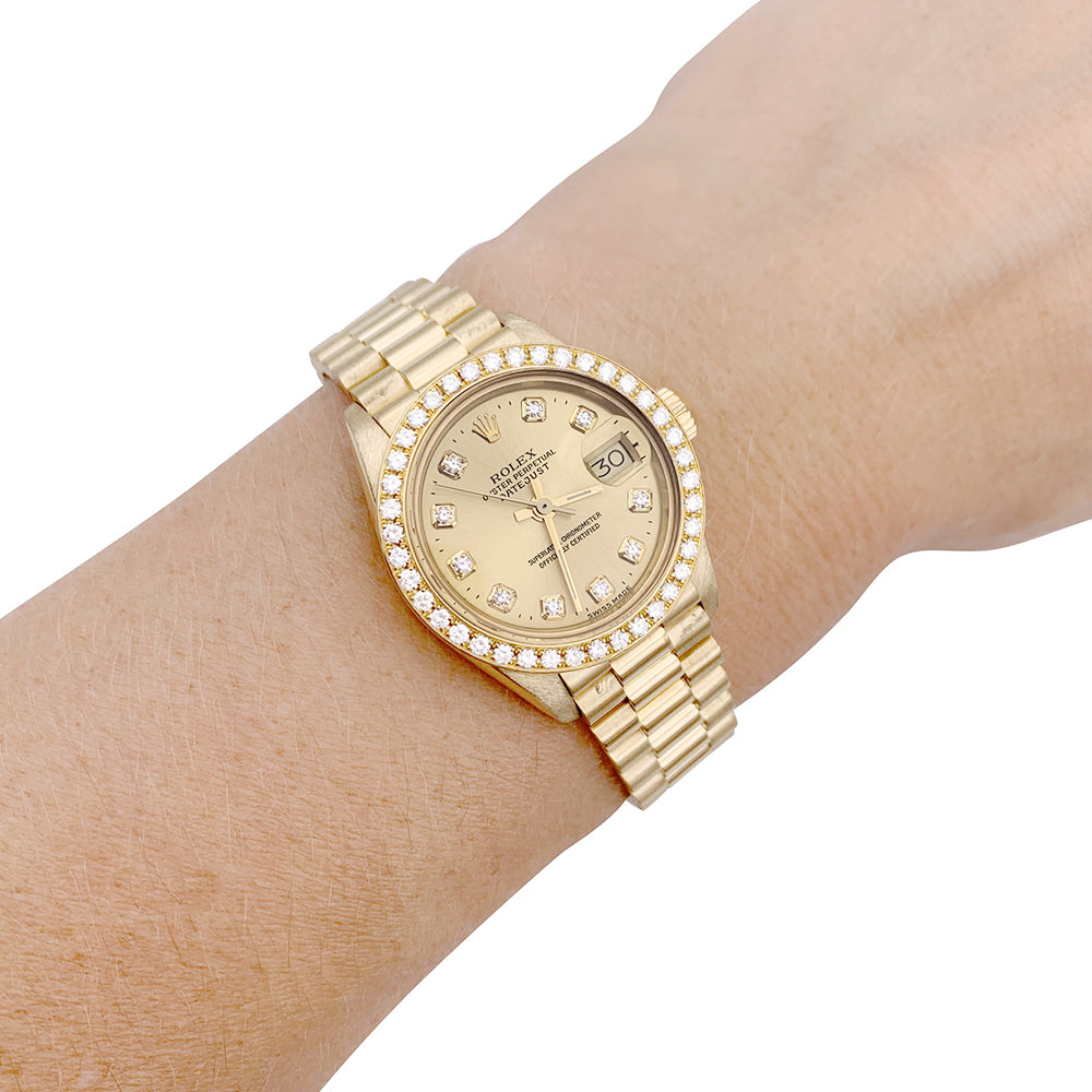 Montre Rolex,"Oyster Pertpetual Datejust", or jaune, diamants.