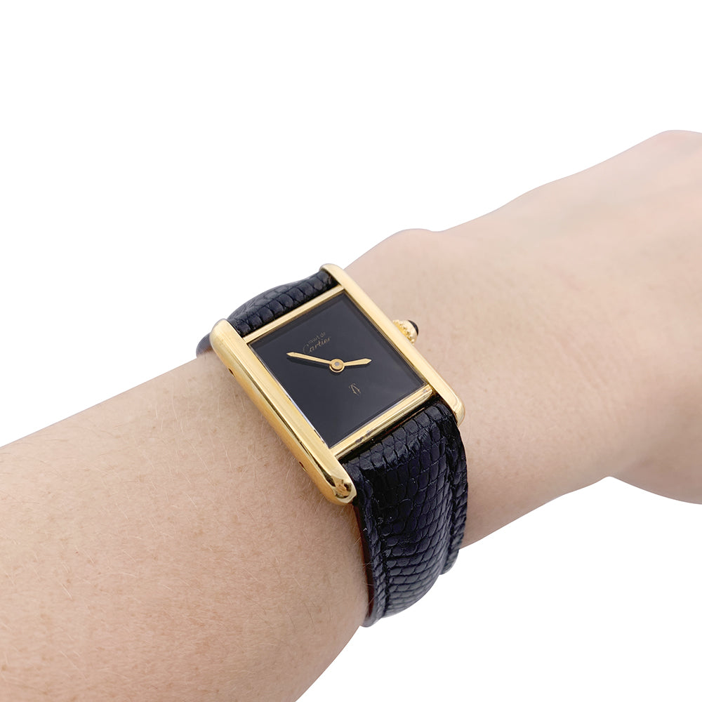 Cartier "Tank Must" watch, gold-plated silver, black lacquered dial.