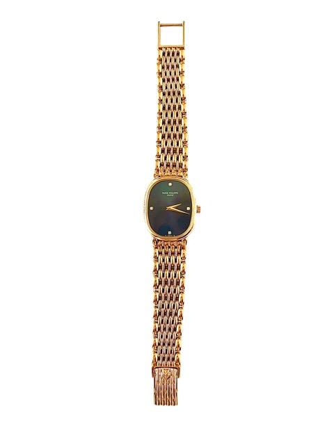 Une montre Patek Philippe vintage en or jaune 18k fond bleu