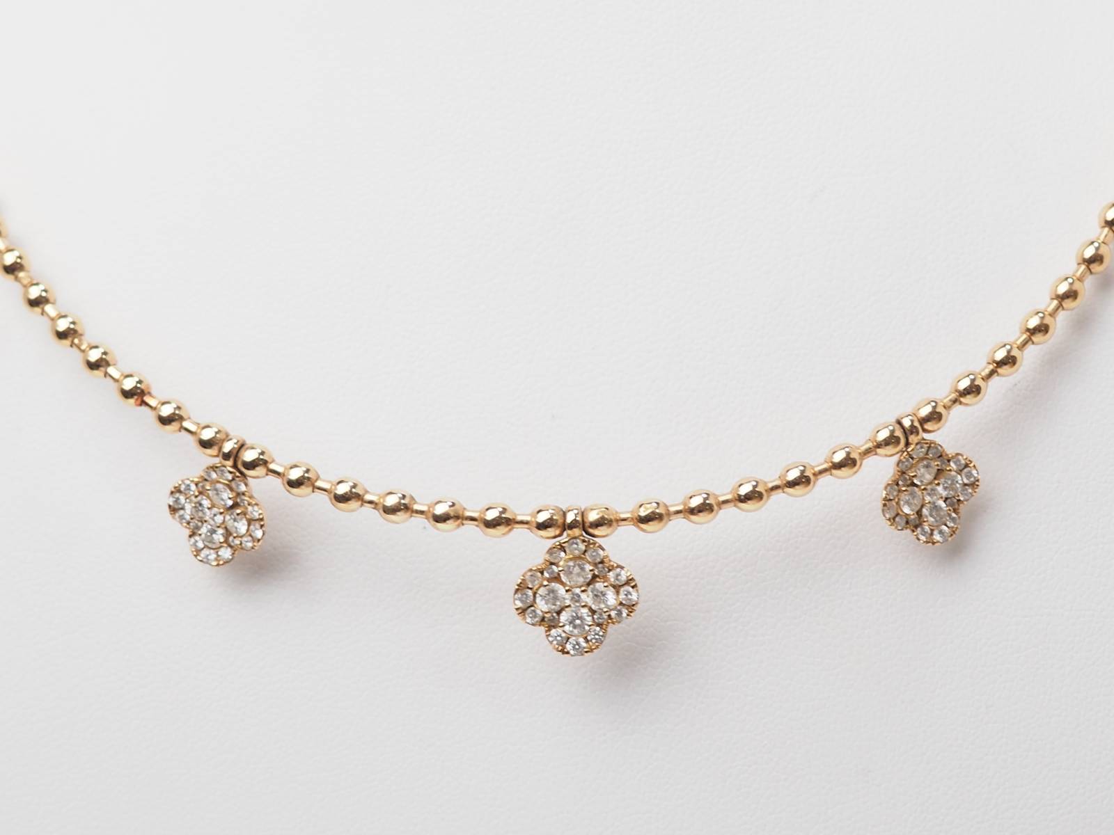 Collier boules rigide et trèfles en or rose et diamants