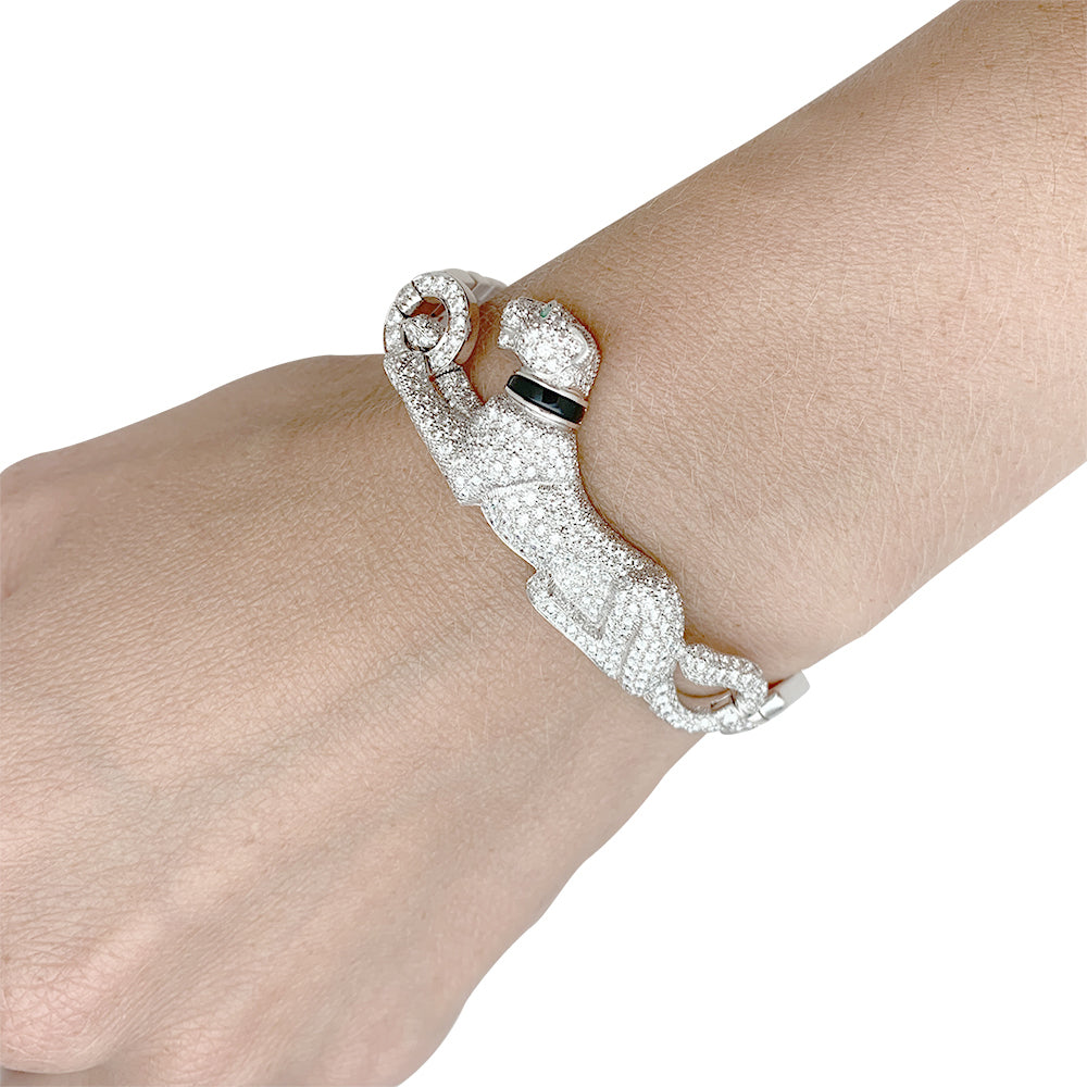 Cartier "Panthère de Cartier" bracelet in white gold, diamonds, emerald and onyx.