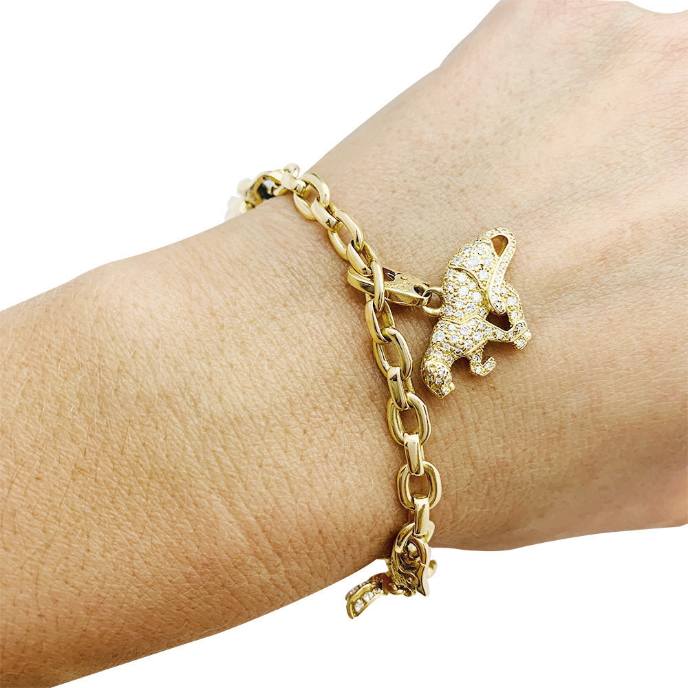 Cartier bracelet in yellow gold, 5 charms, diamonds, emeralds and rubies.