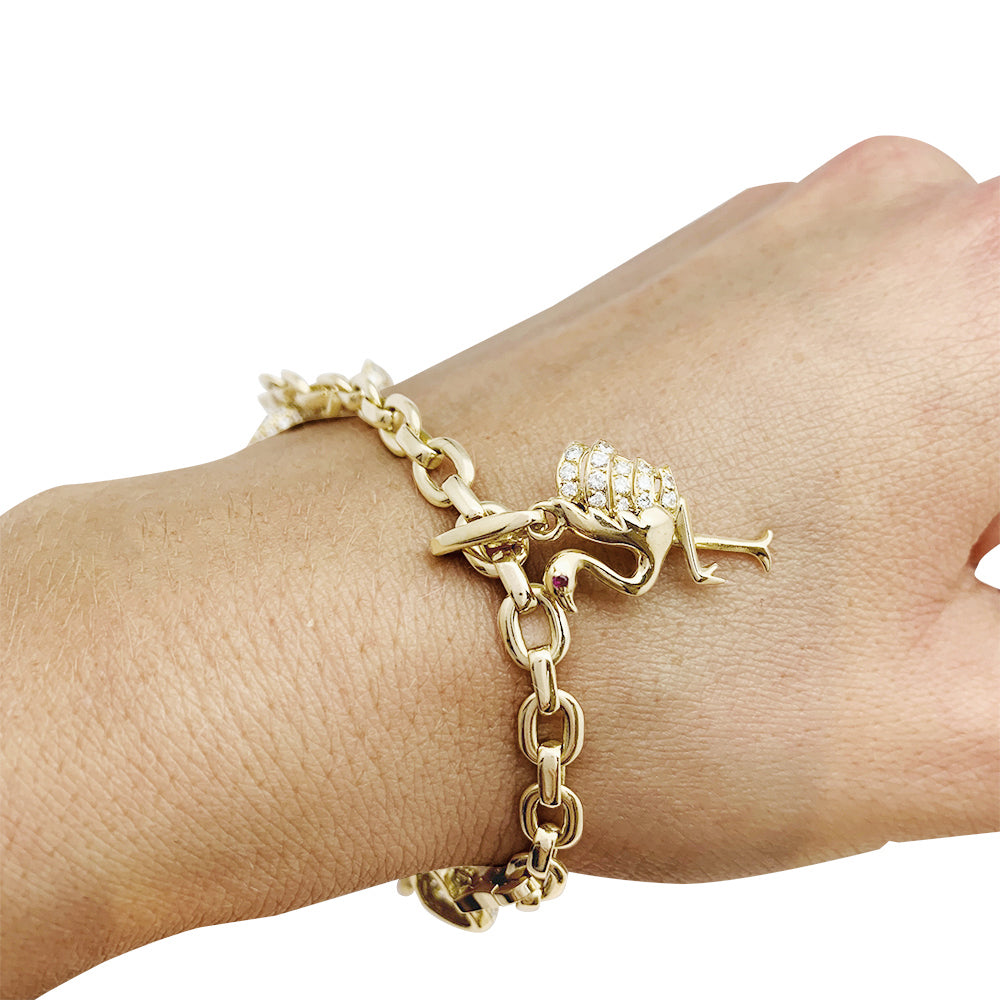 Cartier bracelet in yellow gold, 5 charms, diamonds, emeralds and rubies.