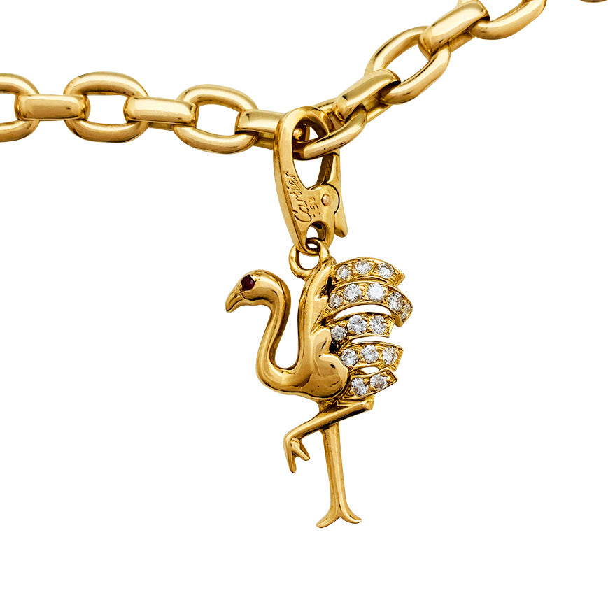 Cartier bracelet in yellow gold, 5 charms, diamonds, emeralds and rubies.