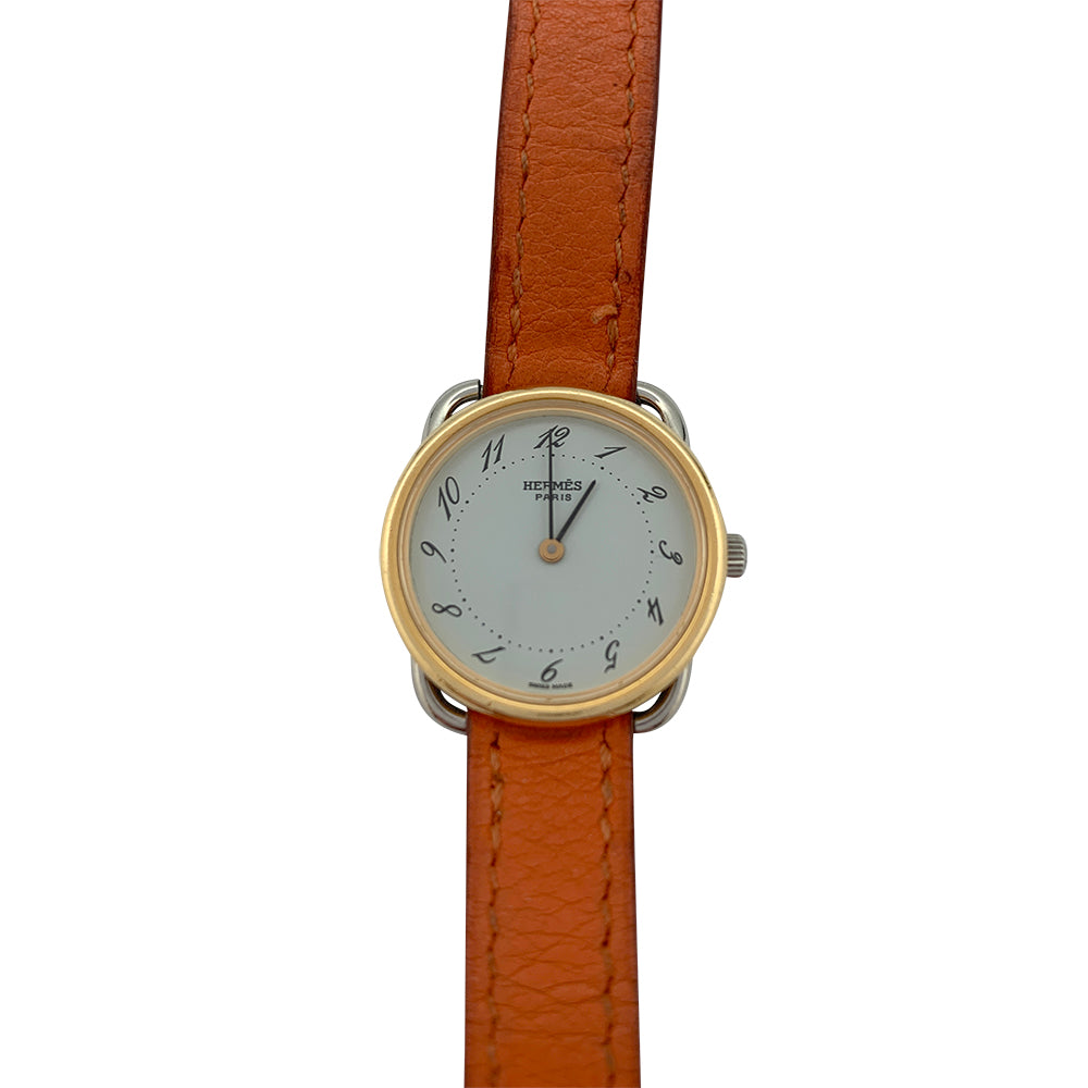 Montre Hermès, "Arceau", plaqué or et acier sur cuir.