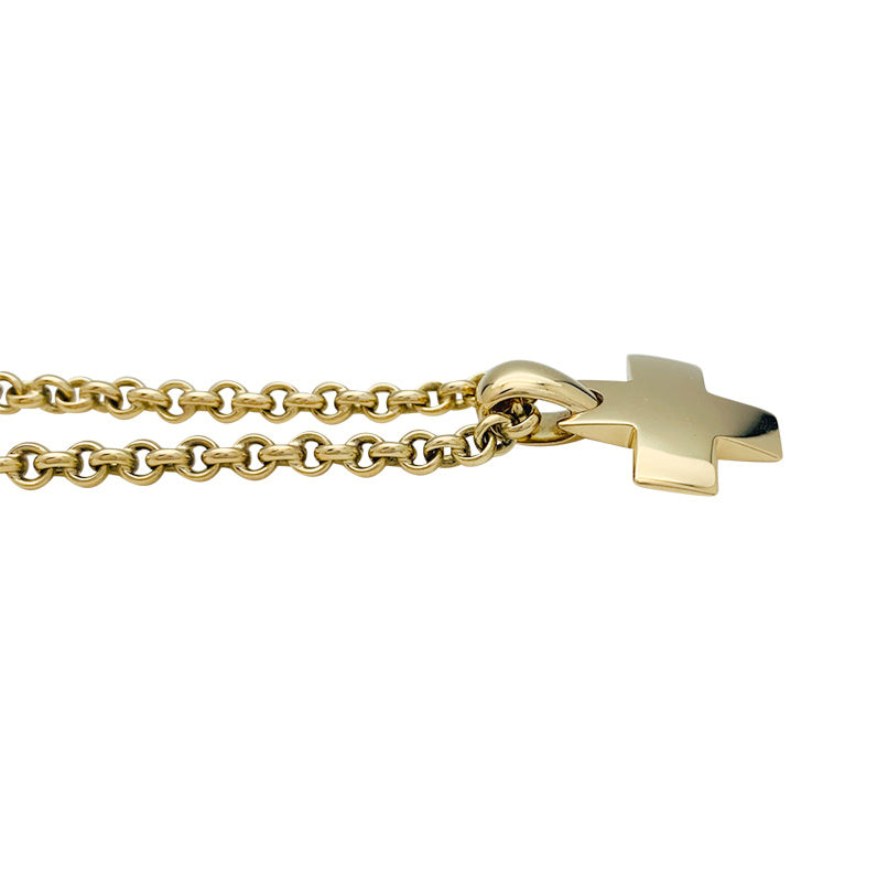 Pomellato "Cross" pendant and chain in yellow gold.