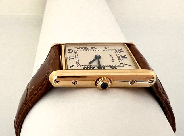 A Cartier Tank women's watch in yellow gold on leather