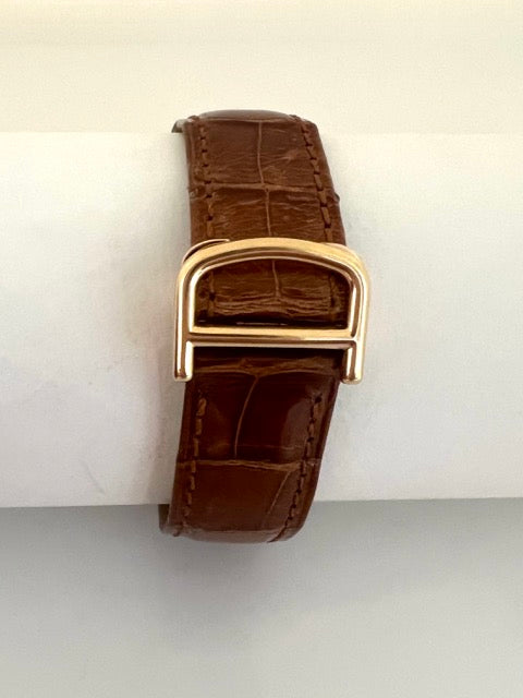 A Cartier Tank women's watch in yellow gold on leather