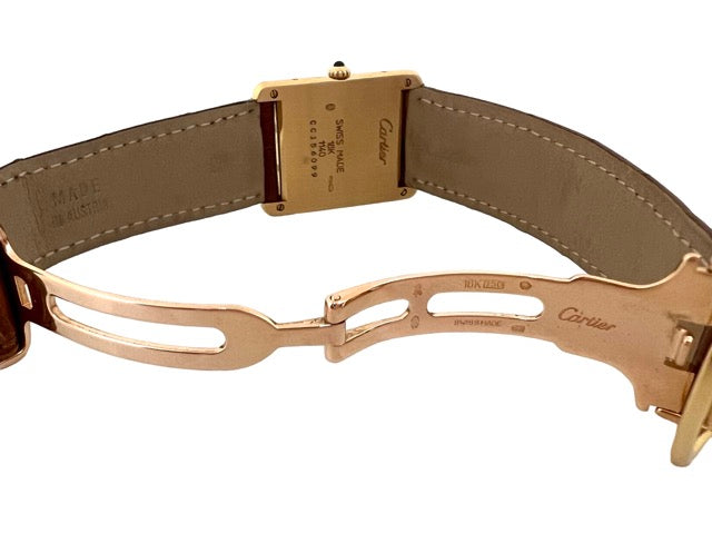 A Cartier Tank women's watch in yellow gold on leather