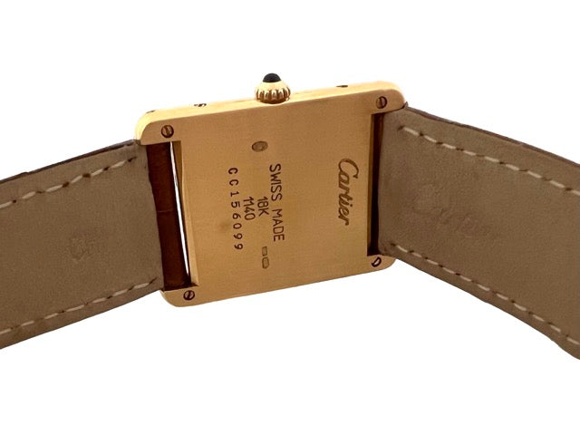 A Cartier Tank women's watch in yellow gold on leather