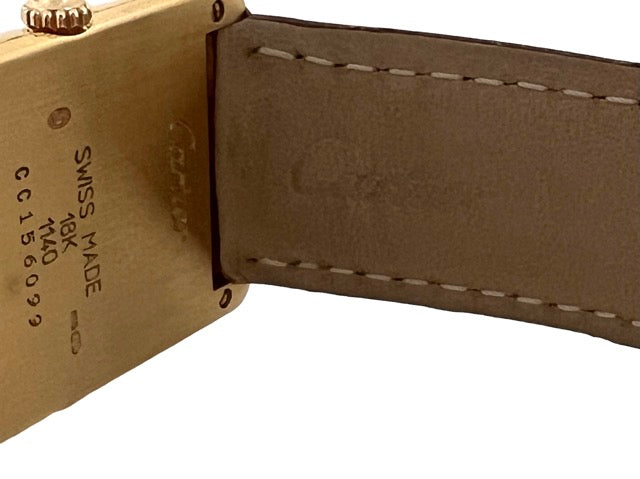 A Cartier Tank women's watch in yellow gold on leather