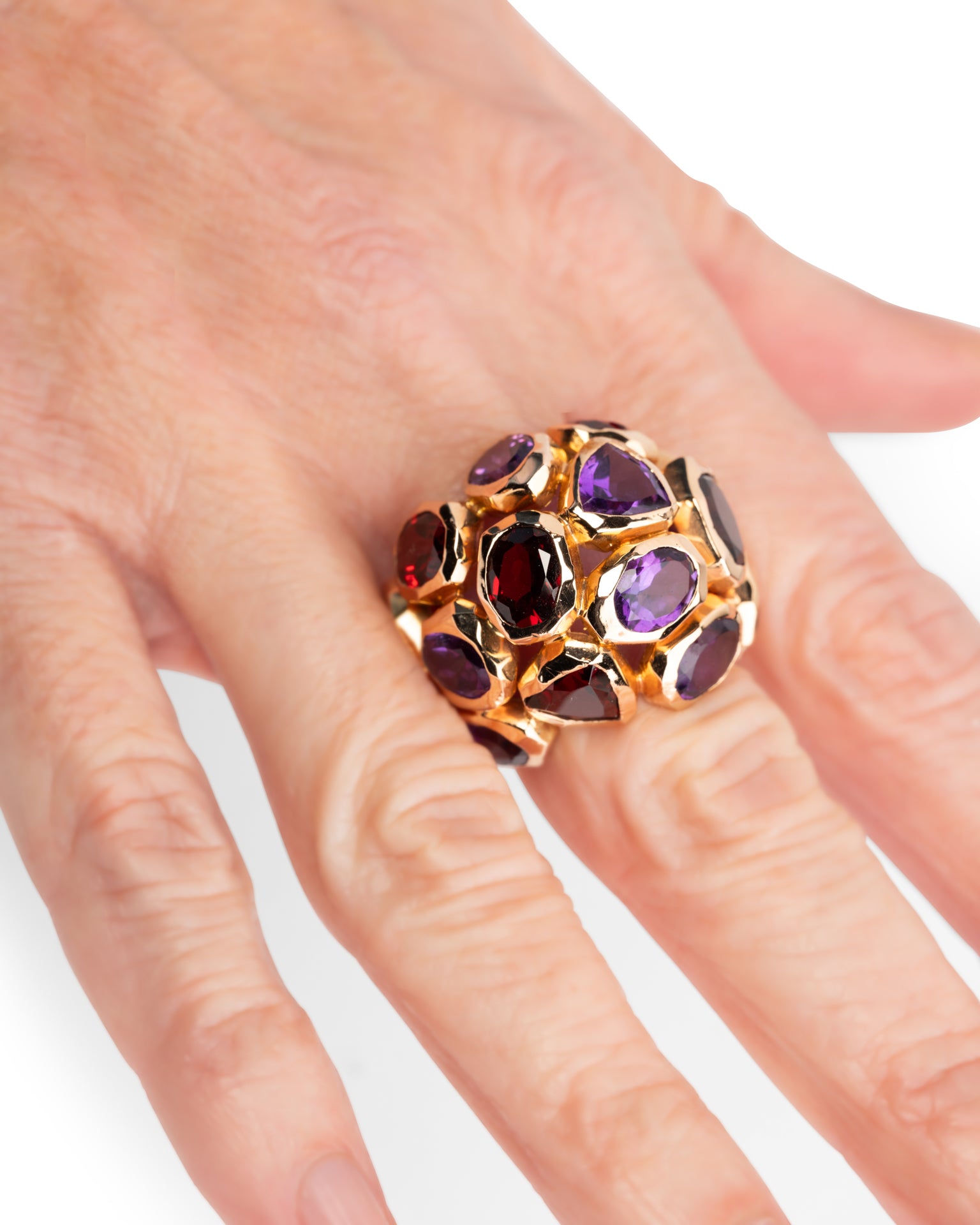 photo portée main de la Bague Cocktail Vintage signée Nardi en or jaune Tourmaline et grenats