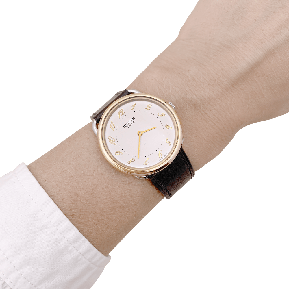 Montre HERMÈS, "Arceau", plaqué or et acier.