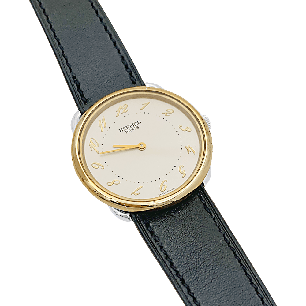 Montre HERMÈS, "Arceau", plaqué or et acier.