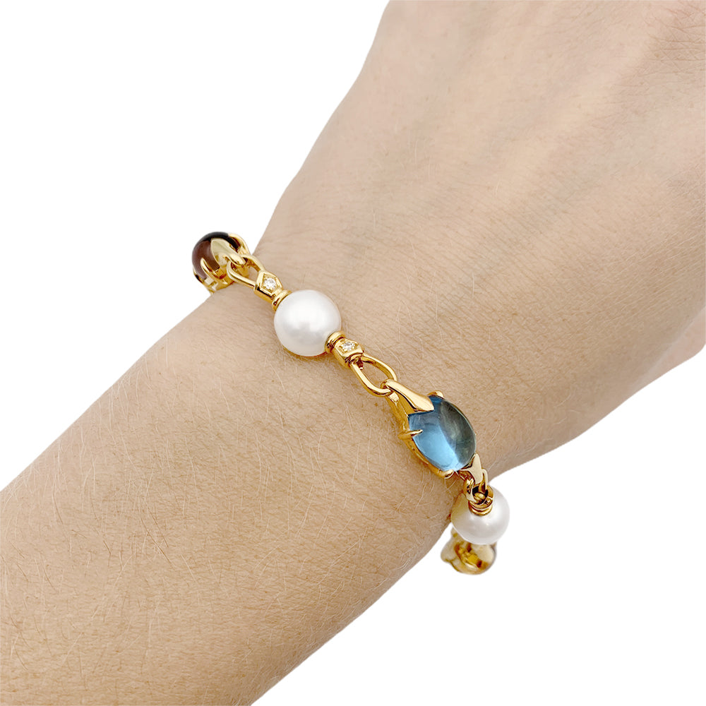 Bulgari bracelet in yellow gold, pearls, colored stones.