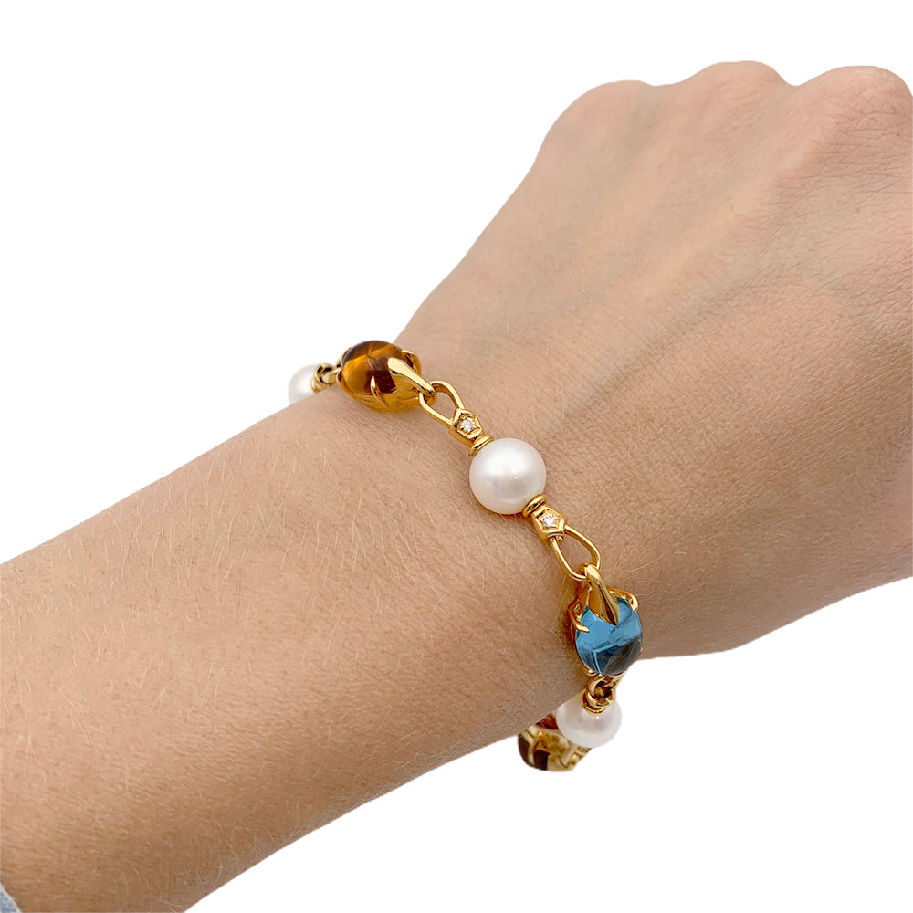 Bulgari bracelet in yellow gold, pearls, colored stones.