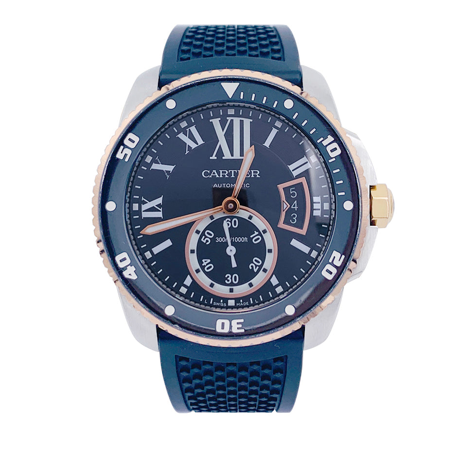 Cartier Calibre watch in gold and steel on a rubber strap.
