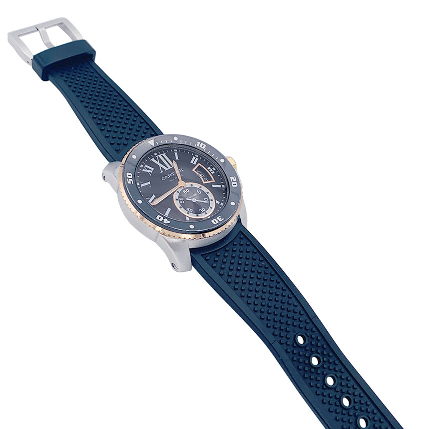 Cartier Calibre watch in gold and steel on a rubber strap.