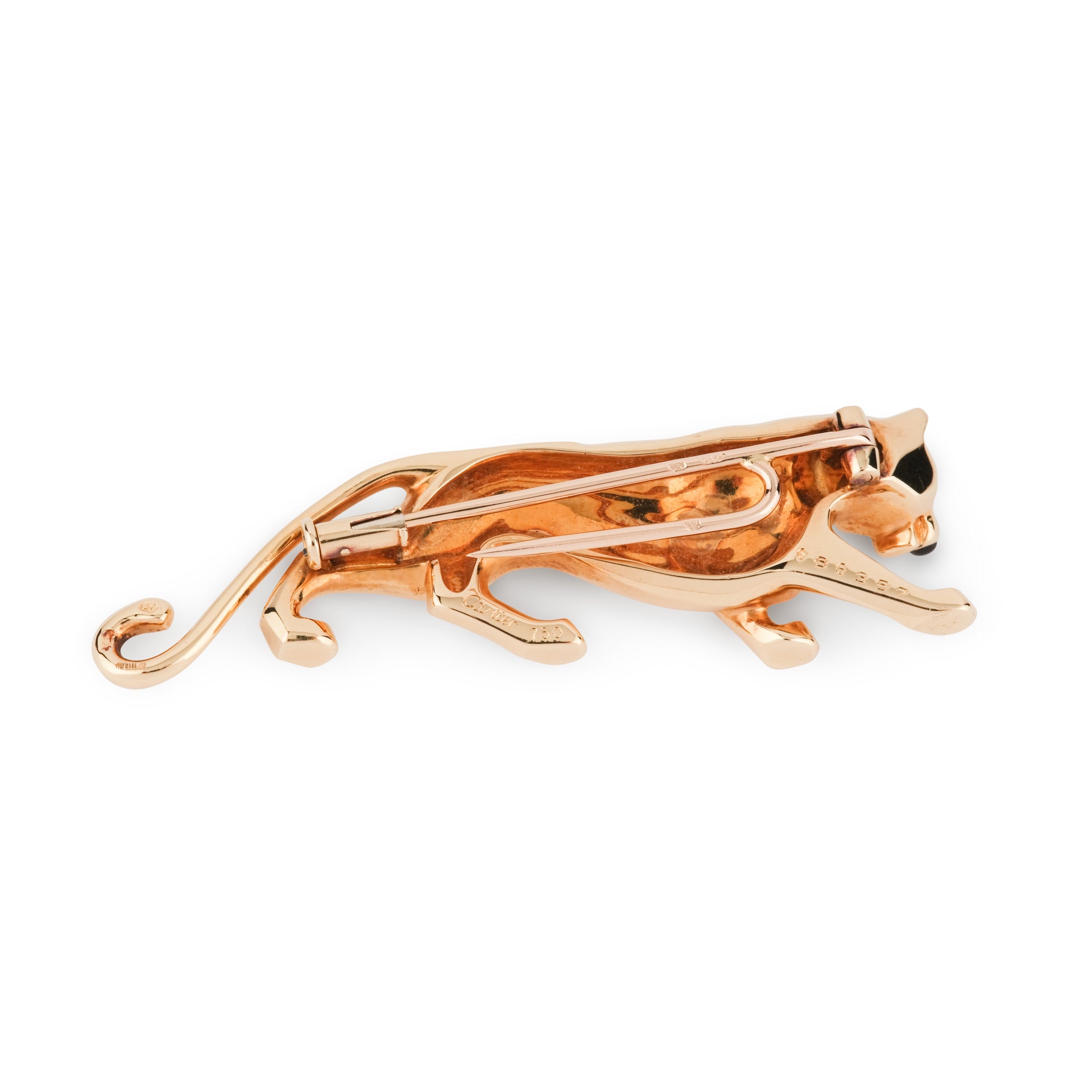 A Cartier "Panthère" brooch in yellow gold, onyx and emerald.