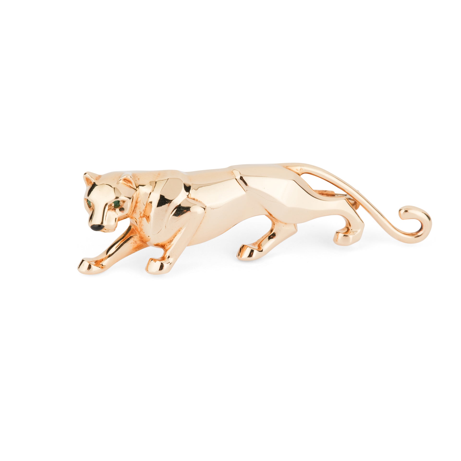 A Cartier "Panthère" brooch in yellow gold, onyx and emerald.