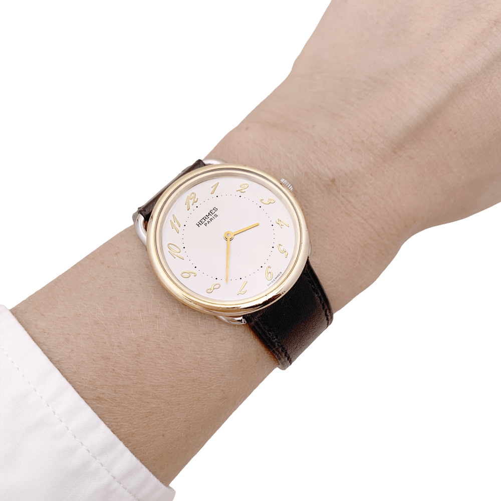Montre HERMÈS, "Arceau", plaqué or et acier.